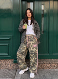 DAXUEN olive camouflage wide-leg pants with pink stripes — model photo