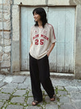 DAXUEN black open-knit mesh top with bold graphics — model photo