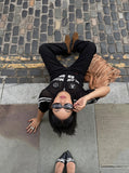 DAXUEN black open-knit mesh top with bold graphics — model photo