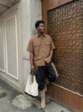 DAXUEN Oversized short-sleeve button-up shirt in cream and brown — model photo