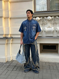 DAXUEN Oversized denim button-up shirt with reflective designs — model photo