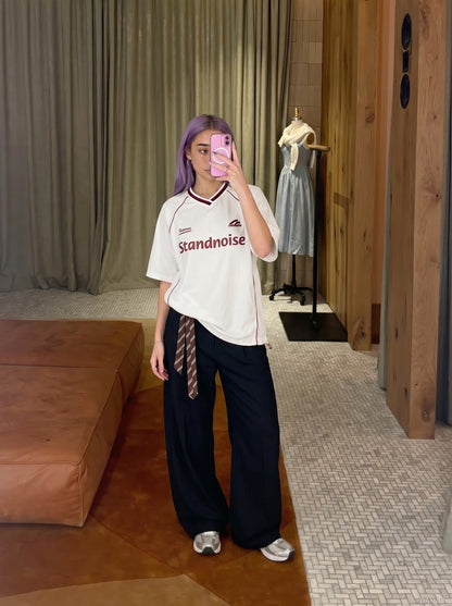 DAXUEN Oversized V-neck graphic t-shirt with drawstring hem — model photo