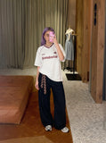 DAXUEN Oversized V-neck graphic t-shirt with drawstring hem — model photo