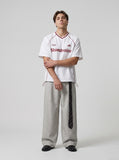 DAXUEN Oversized V-neck graphic t-shirt with drawstring hem — model photo