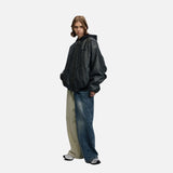 DAXUEN Oversized hooded bomber jacket in black faux leather — model photo