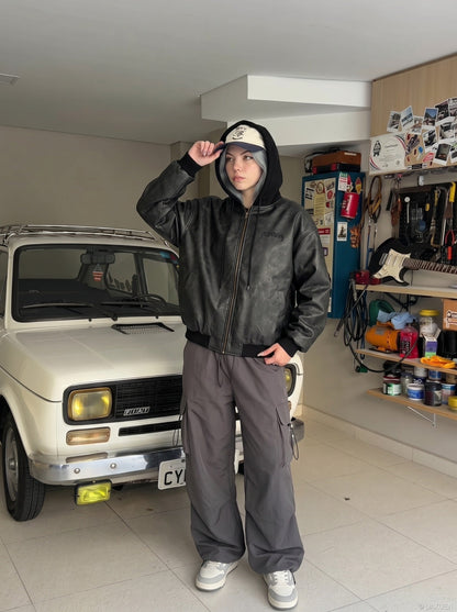 DAXUEN Oversized hooded bomber jacket in black faux leather — model photo