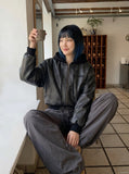 DAXUEN Oversized hooded bomber jacket in black faux leather — model photo