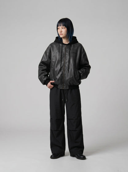 DAXUEN Oversized hooded bomber jacket in black faux leather — model photo