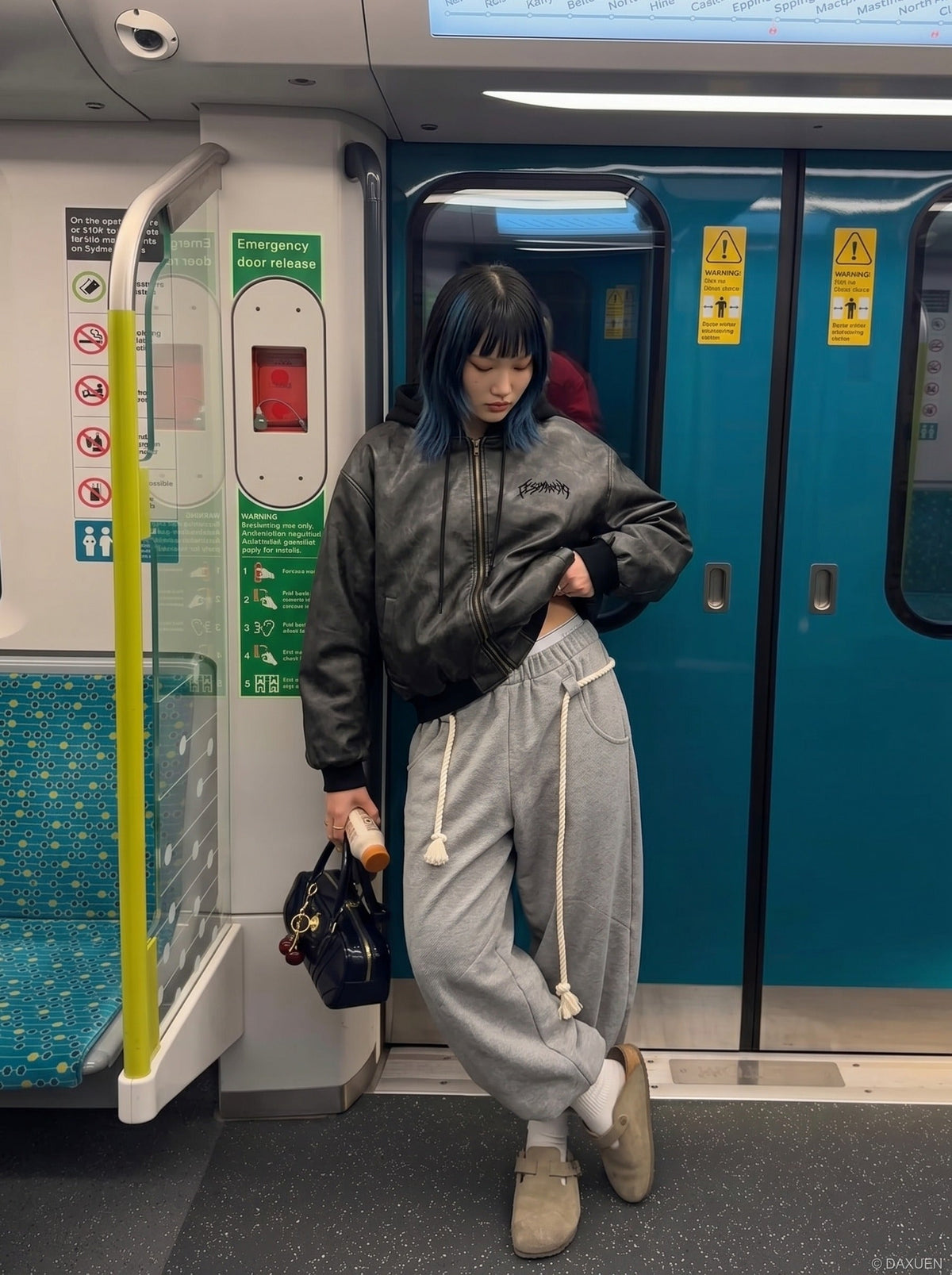 DAXUEN Oversized hooded bomber jacket in black faux leather — model photo