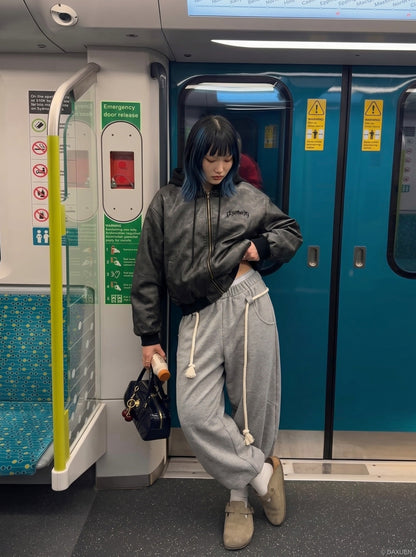 DAXUEN Oversized hooded bomber jacket in black faux leather — model photo