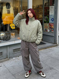 DAXUEN Padded bomber jacket in black and sage green colors — model photo
