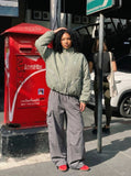 DAXUEN Padded bomber jacket in black and sage green colors — model photo