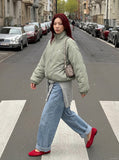 DAXUEN Padded bomber jacket in black and sage green colors — model photo