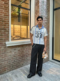DAXUEN light blue and white striped playful graphic polo top — model photo