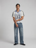 DAXUEN light blue and white striped playful graphic polo top — model photo