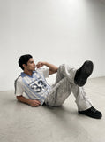 DAXUEN light blue and white striped playful graphic polo top — model photo