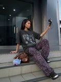 DAXUEN dark grey acid-wash graphic tee with punk portraits — model photo