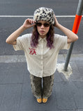 DAXUEN cream oversized striped button-up shirt with red embroidery — model photo