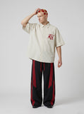 DAXUEN cream oversized striped button-up shirt with red embroidery — model photo