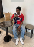 DAXUEN red oversized mesh polo with navy cross graphic — model photo