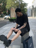 DAXUEN Relaxed fit shorts with crinkled texture and logo — model photo
