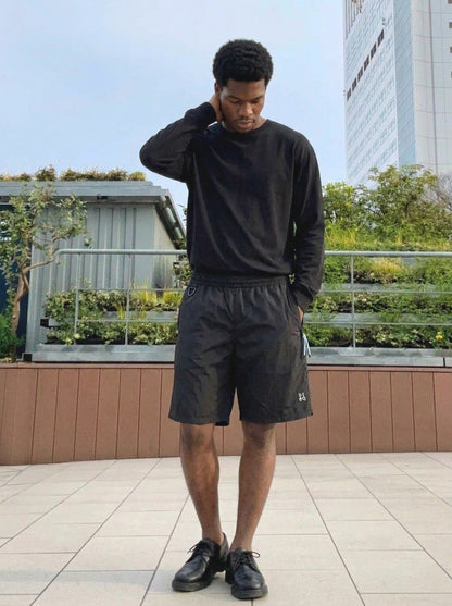 DAXUEN Relaxed fit shorts with crinkled texture and logo — model photo