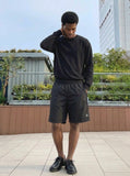 DAXUEN Relaxed fit shorts with crinkled texture and logo — model photo