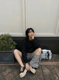 DAXUEN Relaxed fit shorts with crinkled texture and logo — model photo