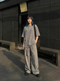 DAXUEN Relaxed oversized short-sleeve top with zippered pockets — model photo