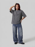 DAXUEN Relaxed oversized short-sleeve top with zippered pockets — model photo