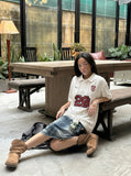 DAXUEN White short-sleeved polo shirt with pinstripes and graphics — model photo