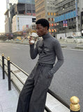 DAXUEN Fitted long-sleeved turtleneck top with star graphic — model photo