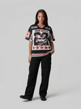 DAXUEN Black and white graphic V-neck t-shirt with red accents — model photo