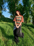DAXUEN rusty red striped script oversized T-shirt — model photo