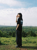 DAXUEN black oversized rocky-coastline graphic tee — model photo