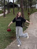DAXUEN Relaxed-fit short-sleeve T-shirt with script embroidery — model photo