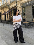DAXUEN Graphic V-neck t-shirt with embroidered designs — model photo