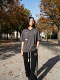 DAXUEN Graphic V-neck t-shirt with embroidered designs — model photo