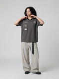DAXUEN Graphic V-neck t-shirt with embroidered designs — model photo