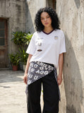 DAXUEN Graphic V-neck t-shirt with embroidered designs — model photo