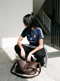 DAXUEN navy blue shield crest contrast stripe athletic tee — model photo