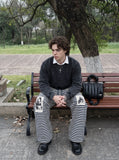 DAXUEN striped wide-leg pants with skull and structure patches — model photo