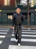 DAXUEN black leather-look jacket with zippered details — model photo