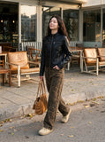 DAXUEN black leather-look jacket with zippered details — model photo