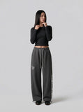 DAXUEN Dark grey wide leg sweatpants with unique graphics — model photo