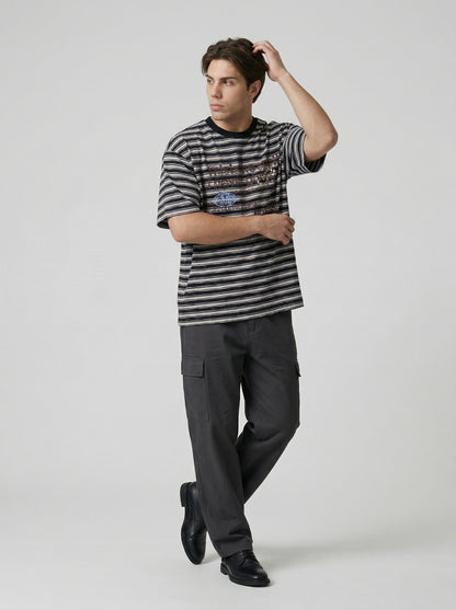 DAXUEN Striped crewneck T-shirt with distressed text print — model photo