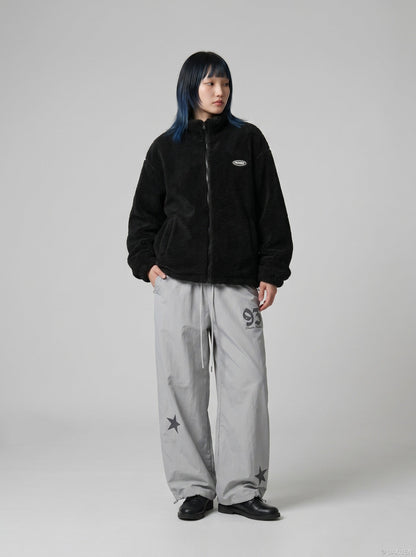 DAXUEN Wide-leg track pants with star graphics — model photo