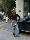 DAXUEN Wide-leg denim jeans with star print and distressed details — model photo