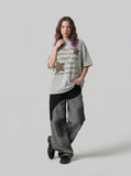 DAXUEN Oversized short-sleeved T-shirt with graphic text and star patches — model photo
