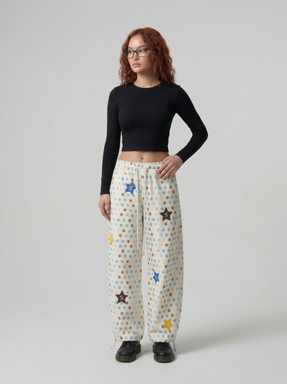 DAXUEN Cream wide-leg pants with star print and embroidery — model photo